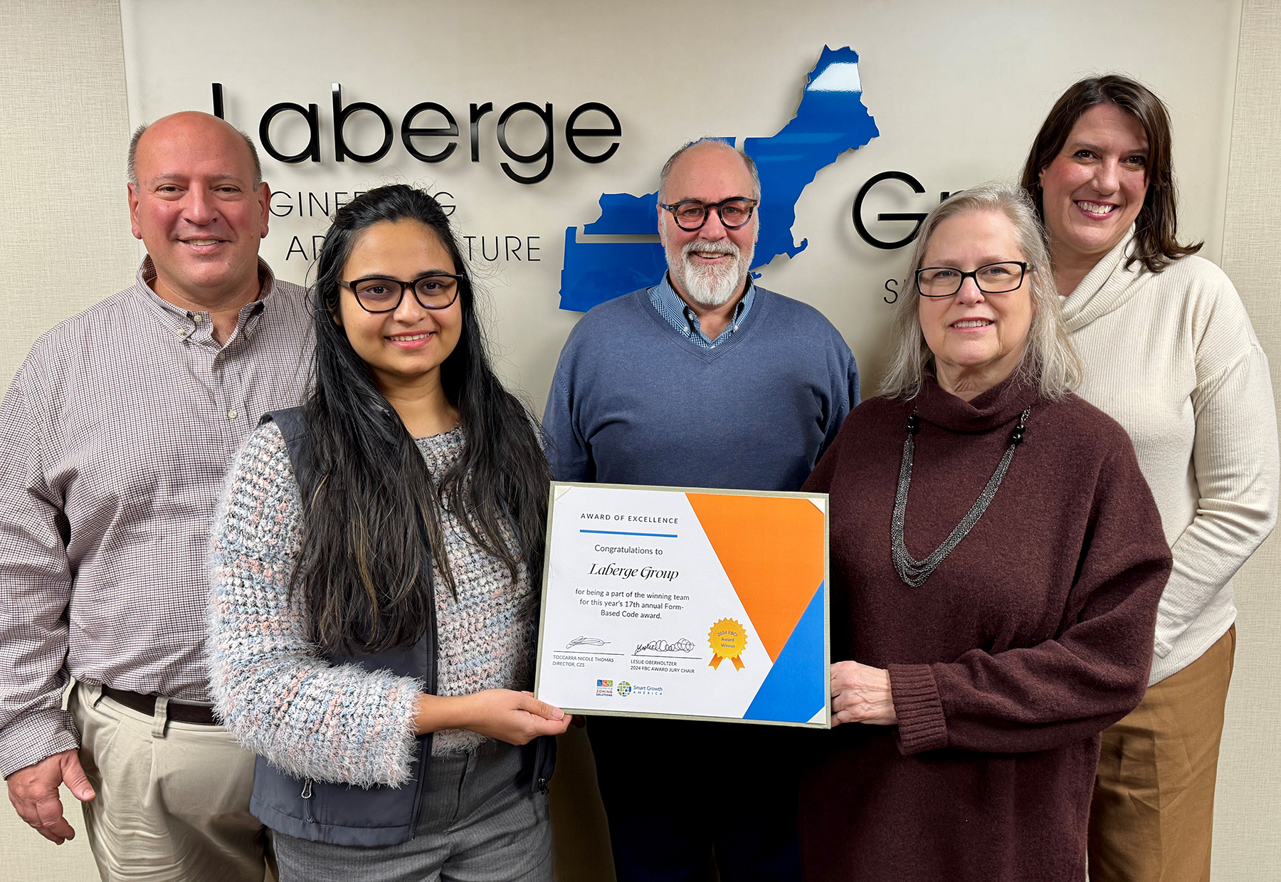 Laberge Group planning team members holding an award.